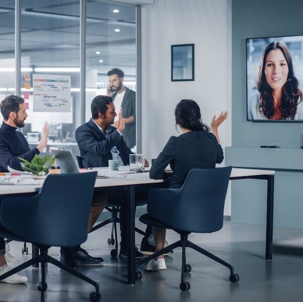 Businesspeople,Do,Video,Conference,Call,With,Big,Wall,Tv,In Businesspeople on a web meeting with boss